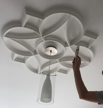 Detailed ceiling rose being painted